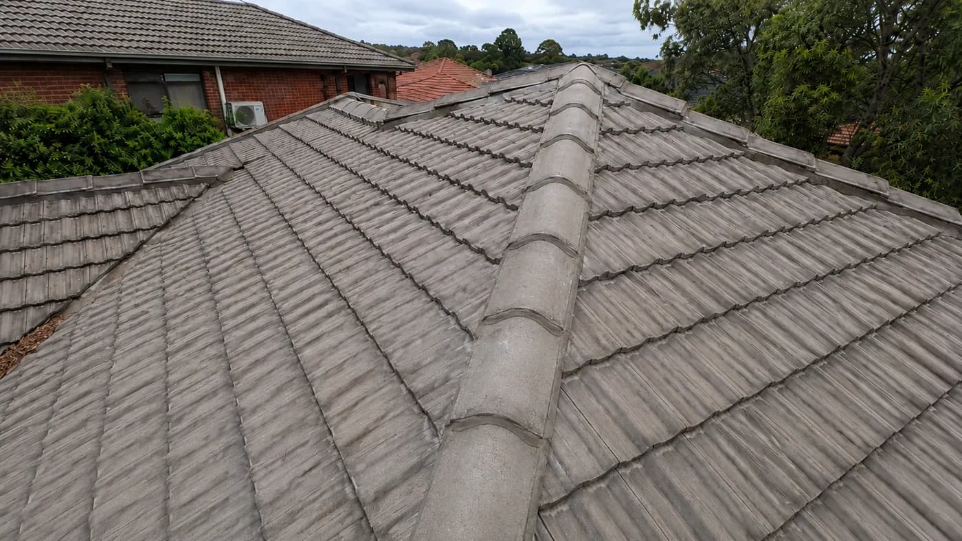 Storm clouds over a Melbourne suburb roofline